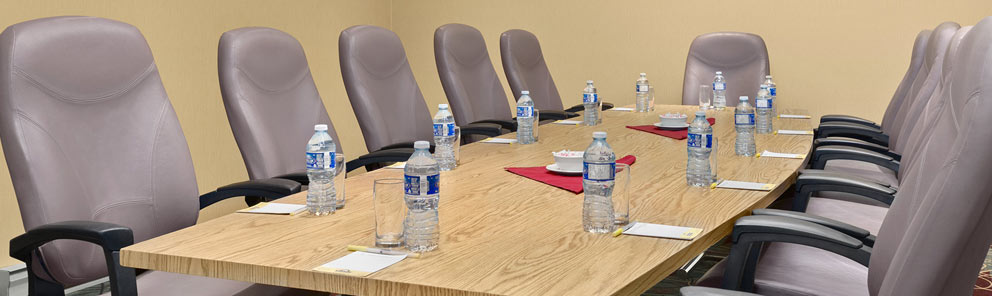 A large boardroom with a large table, water bottles & more at the Days Inn Stephenville hotel