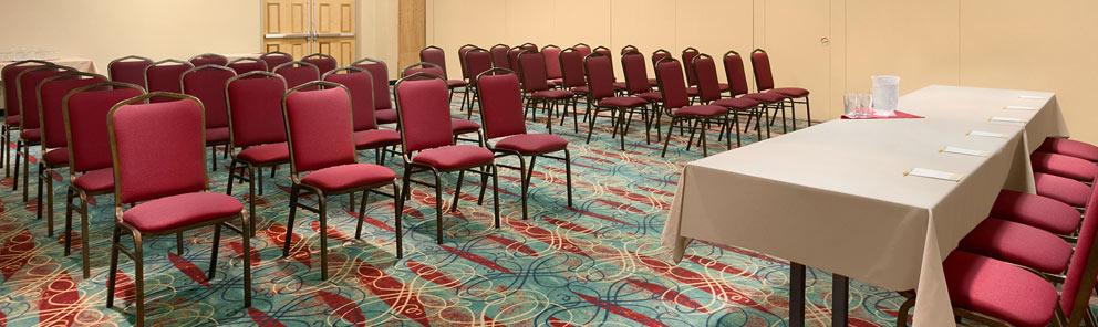 A spacious meeting room with rows of chairs at the Days Inn Stephenville hotel located near the Stephenville airport