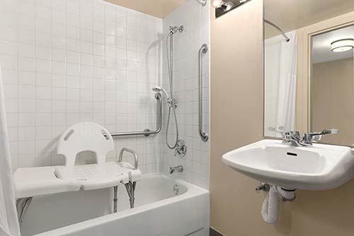 A large accessible bathroom at the Days Inn Stephenville hotel located near the St. George blueberry festival