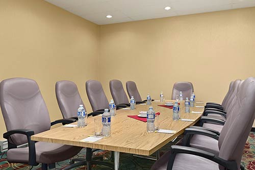 A large boardroom with premium rolling chairs, a large table & more at the Days Inn Stephenville hotel