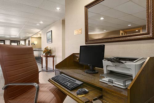 The business center at the Days Inn Stephenville hotel featuring a computer and printer