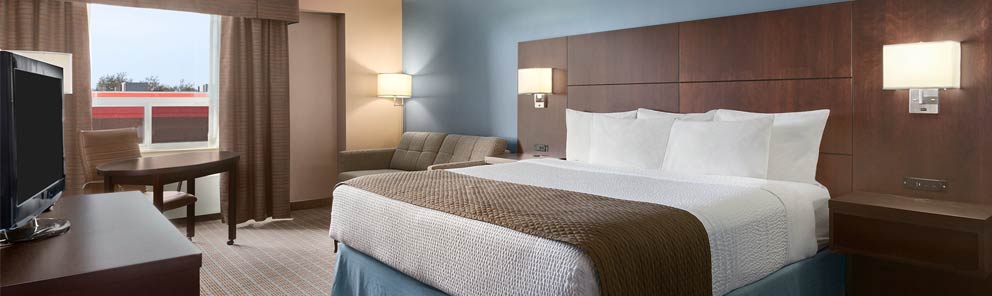 An executive suite featuring a comfortable bed, work desk & more at the Days Inn Stephenville