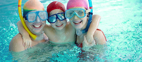 A happy family playing in the offsite pool at the Days Inn Stephenville